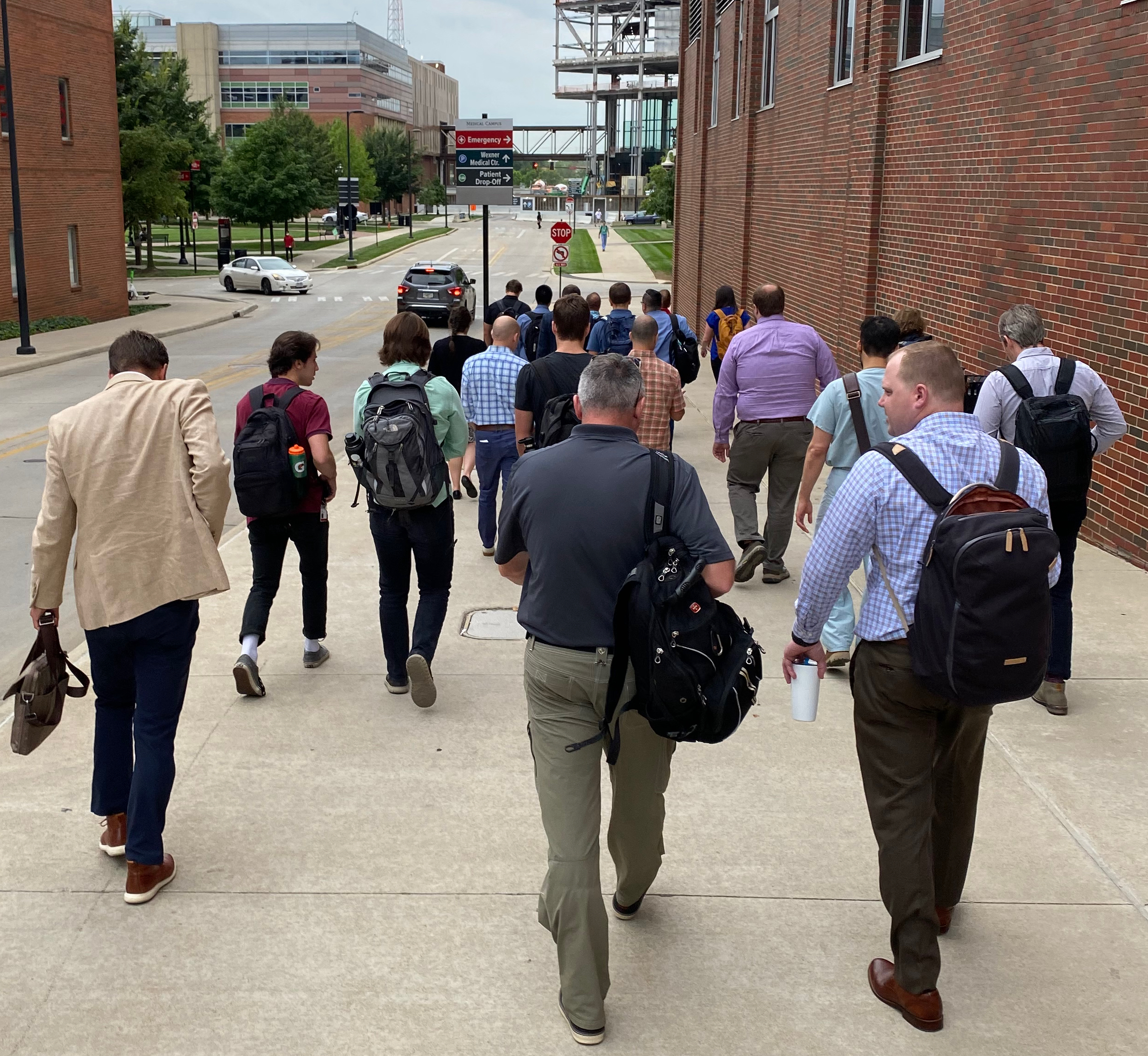 Workshop participants walk to The James-Comprehensive Cancer Center to virtually observe a surgery.