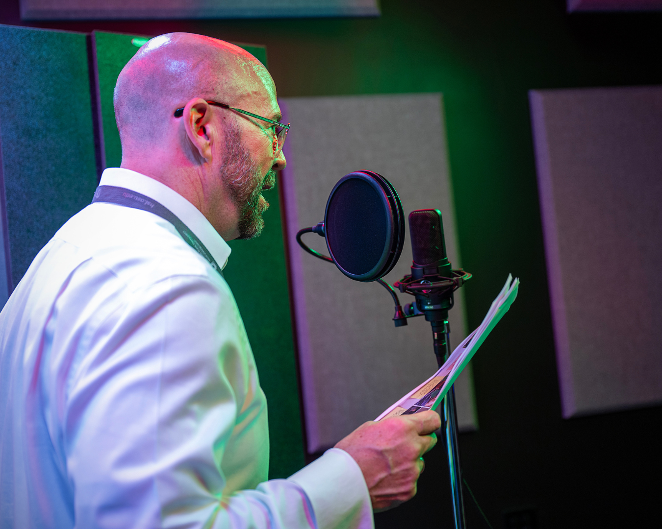 Man reading script into microphone.