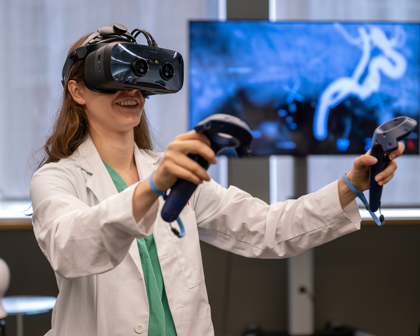 Female medical student using VR headset for anatomy visualization.