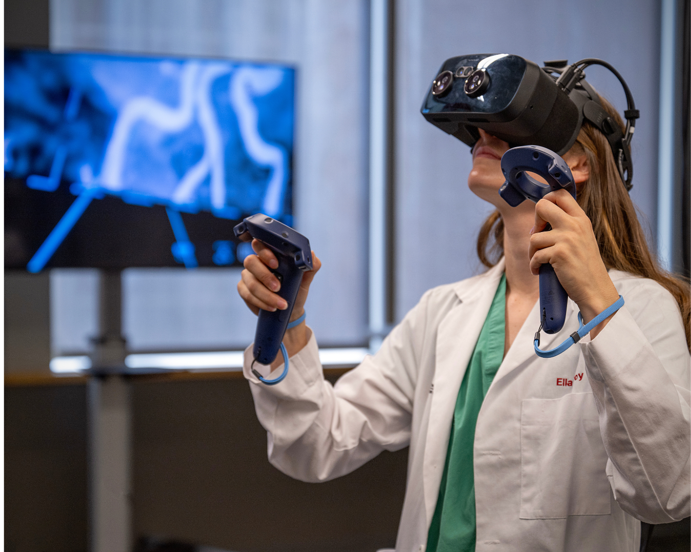 Female medical student looks up using VR headset for anatomy visualization.