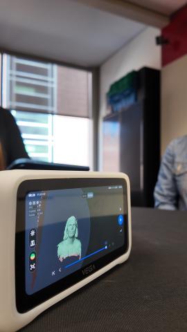 The digital screen on the Einstar Vega hand-held 3D scanner shows a subject’s head and shoulders that was just scanned into the unit’s software.