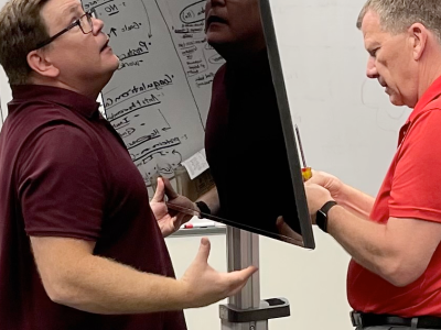 Dr. Doug Danforth and Kellen Maicher from The Ohio State University College of Medicine install a TV in the EdTech Incubator VR Zone.