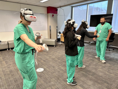medical students in scrubs using VR headseat