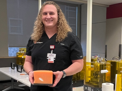 Joshua Krech holds a 3D printed model in the EdTech Incubator's 3D printing lab