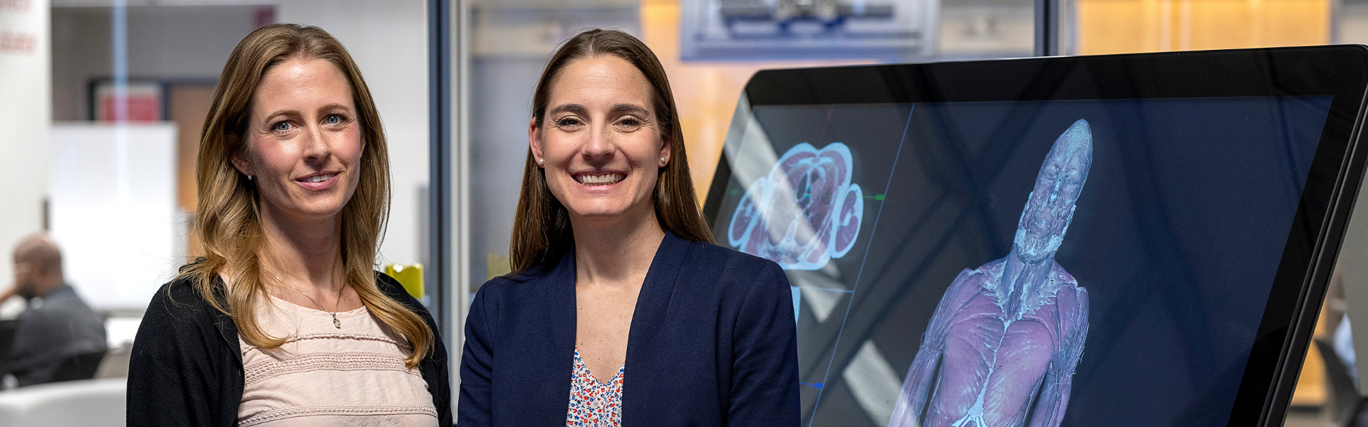 Kristin Roberts and Laura Boucher stand beside The Ohio State University Health Sciences Library's EdTech Incubator's anatomy Sectra table